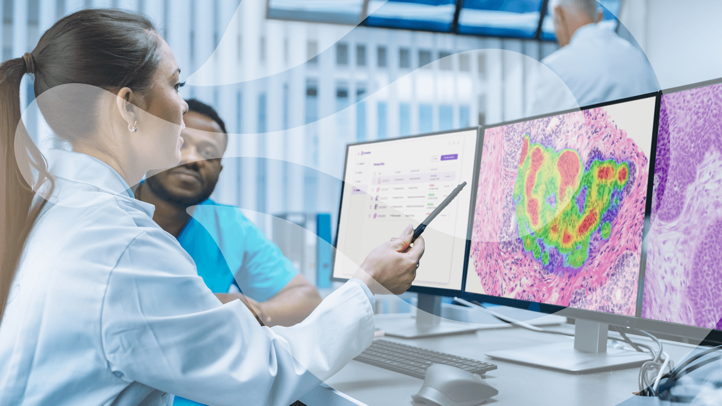 Co-workers review data from AI-based cancer diagnostic tools for their hospital